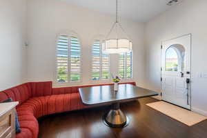 Dining space featuring breakfast area, dark wood-type flooring, and healthy amount of natural light