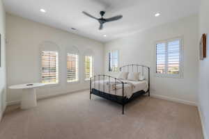 Bedroom featuring light carpet, multiple windows, a ceiling fan, and recessed lighting