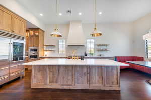 Kitchen featuring open shelves, stainless steel appliances, a spacious island, wood finish cabinetry, and dark wood-type flooring