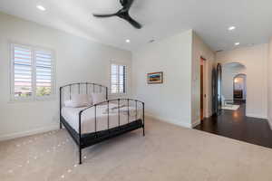 Bedroom featuring arched walkways, dark carpet, a ceiling fan, and recessed lighting