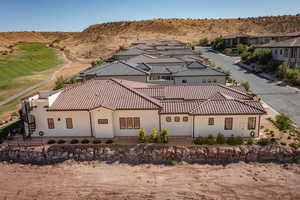 Side view of property with stucco siding, a residential view, a patio, and a mountain view