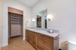 Bathroom with vanity, light tile patterned flooring, and a stall shower