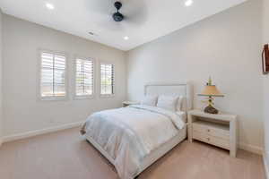 Bedroom with ceiling fan, light carpet, and recessed lighting