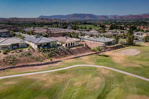Aerial perspective of suburban area with mountains and a golf club