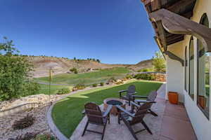 View of patio with a mountain view and view of golf course
