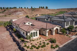 View of front of home with an attached garage, stucco siding, driveway, a tiled roof, and a mountain view