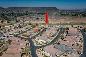 Aerial view of property's location featuring nearby suburban area and mountains