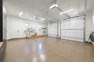 Garage with baseboards and a garage door opener