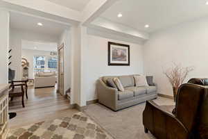 Living area with recessed lighting and light wood-type flooring