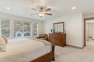 Bedroom with light carpet, a ceiling fan, and recessed lighting