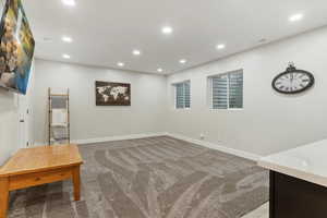 Below grade area featuring light colored carpet and recessed lighting