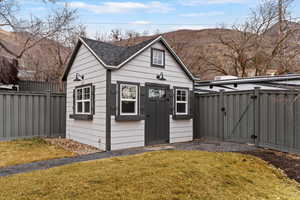 View of outbuilding with a gate and a mountain view