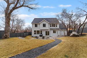 Back of property featuring stucco siding, a patio, a fenced backyard, and a shingled roof