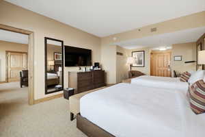 Bedroom with light carpet and baseboards