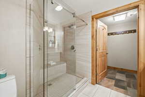 Bathroom featuring toilet and a shower stall