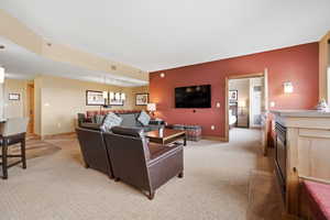 Living room featuring light colored carpet and baseboards