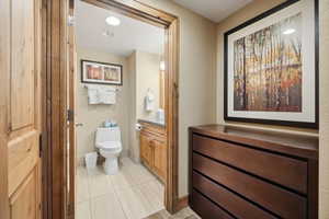 Bathroom featuring vanity, light tile patterned flooring, and recessed lighting