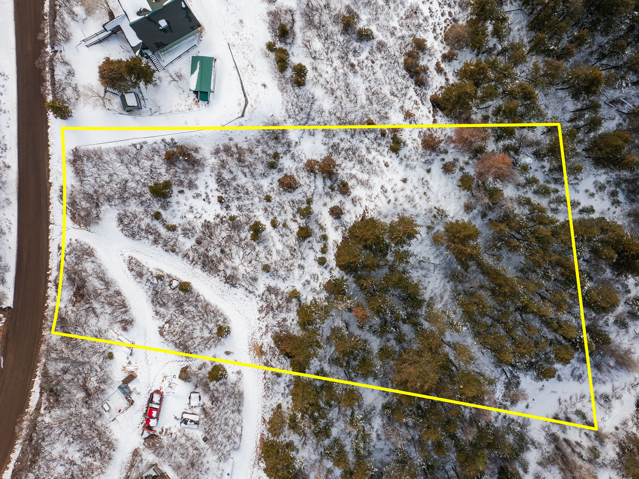 Snowy aerial view featuring property boundaries highlighted