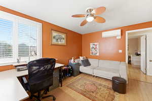 Office area with light wood-style flooring, a mini split for heating / cooling, and ceiling fan