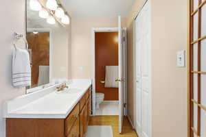 Bathroom with vanity and light wood-style flooring