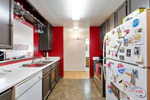 Kitchen featuring white appliances and light countertops