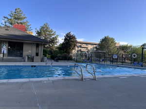 Community pool with a patio
