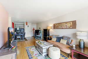 Living room with light wood-style flooring