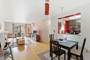 Dining area with light wood-style flooring and baseboards