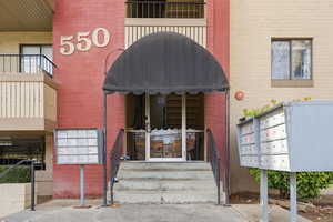 View of exterior entry featuring brick siding