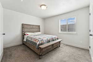 Bedroom with light carpet and a textured ceiling