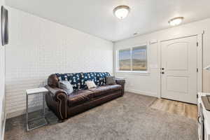 Carpeted living room with a textured ceiling and an accent wall