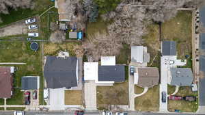 Aerial view of property and surrounding area featuring nearby suburban area