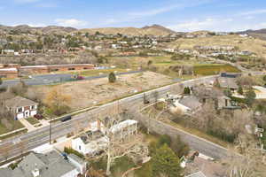 Aerial view of property's location with nearby suburban area and a mountain backdrop