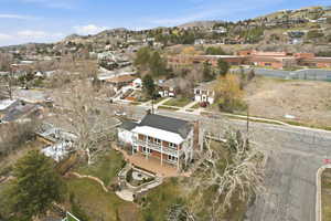 Aerial overview of property's location with a mountainous background and nearby suburban area