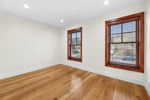 Spare room with light wood-style floors and recessed lighting
