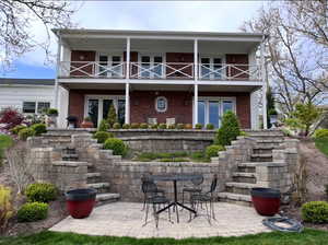 Rear view of property with a patio, brick siding, and outdoor dining space