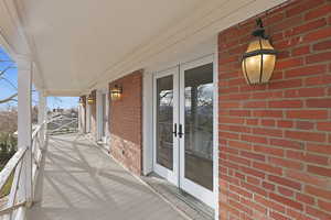 Covered porch featuring french doors