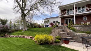 View of grassy yard with a patio area