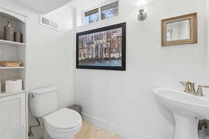 Bathroom with baseboards and toilet