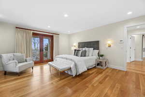 Bedroom featuring french doors, light wood-style floors, access to outside, and recessed lighting