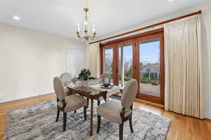 Dining space with light wood-style flooring and hanging lights