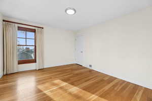 Unfurnished room with light wood-style flooring and baseboards