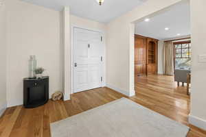Entryway with light wood finished floors and recessed lighting
