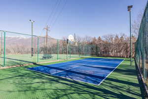View of tennis court with community basketball court