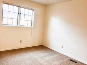 Empty room with baseboards and carpet flooring
