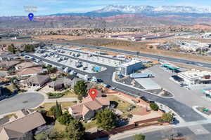 Aerial view of property and surrounding area with a mountain backdrop