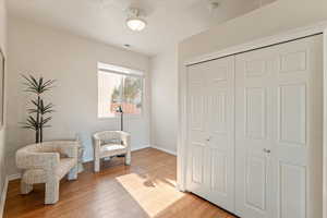 Sitting room featuring light wood-style flooring and baseboards