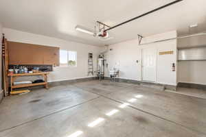 Garage with baseboards and water heater