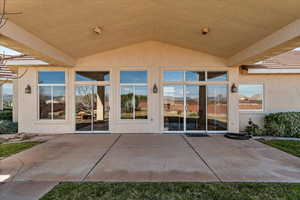 Entrance to property featuring a patio and stucco siding