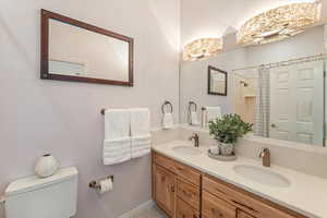 Bathroom with double vanity and a shower with shower curtain
